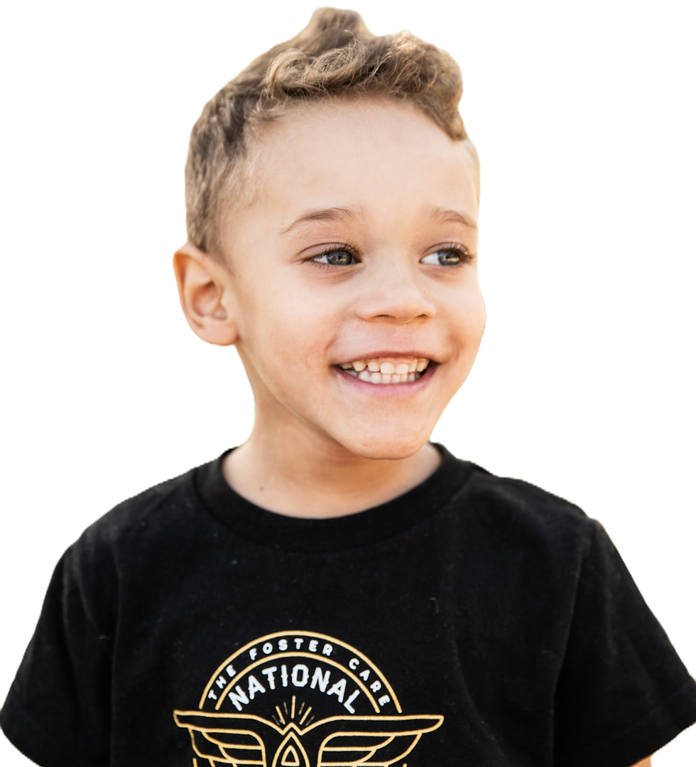 Smiling young boy in a black shirt against a light gray background.